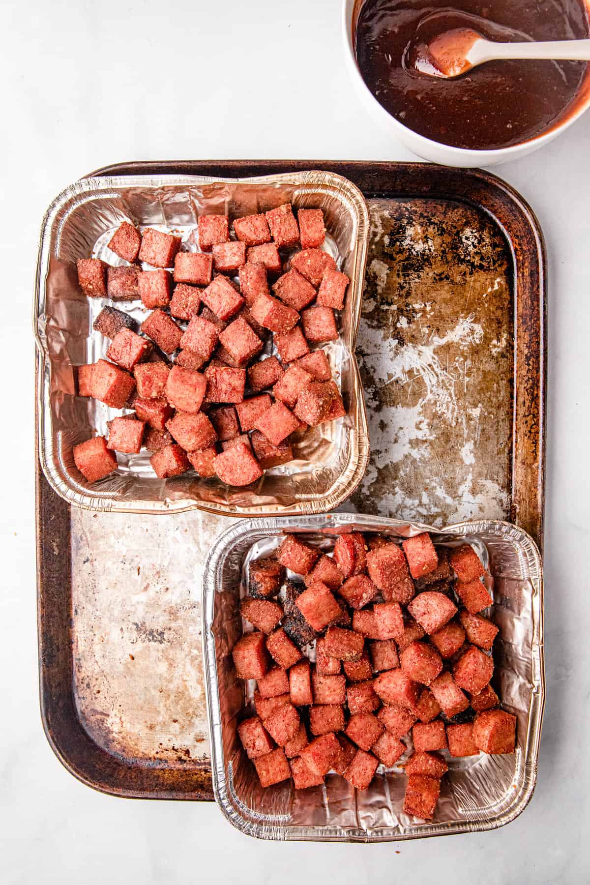 Smoked Spam pieces in square baking tin before adding BBQ sauce for Spam Burnt Ends