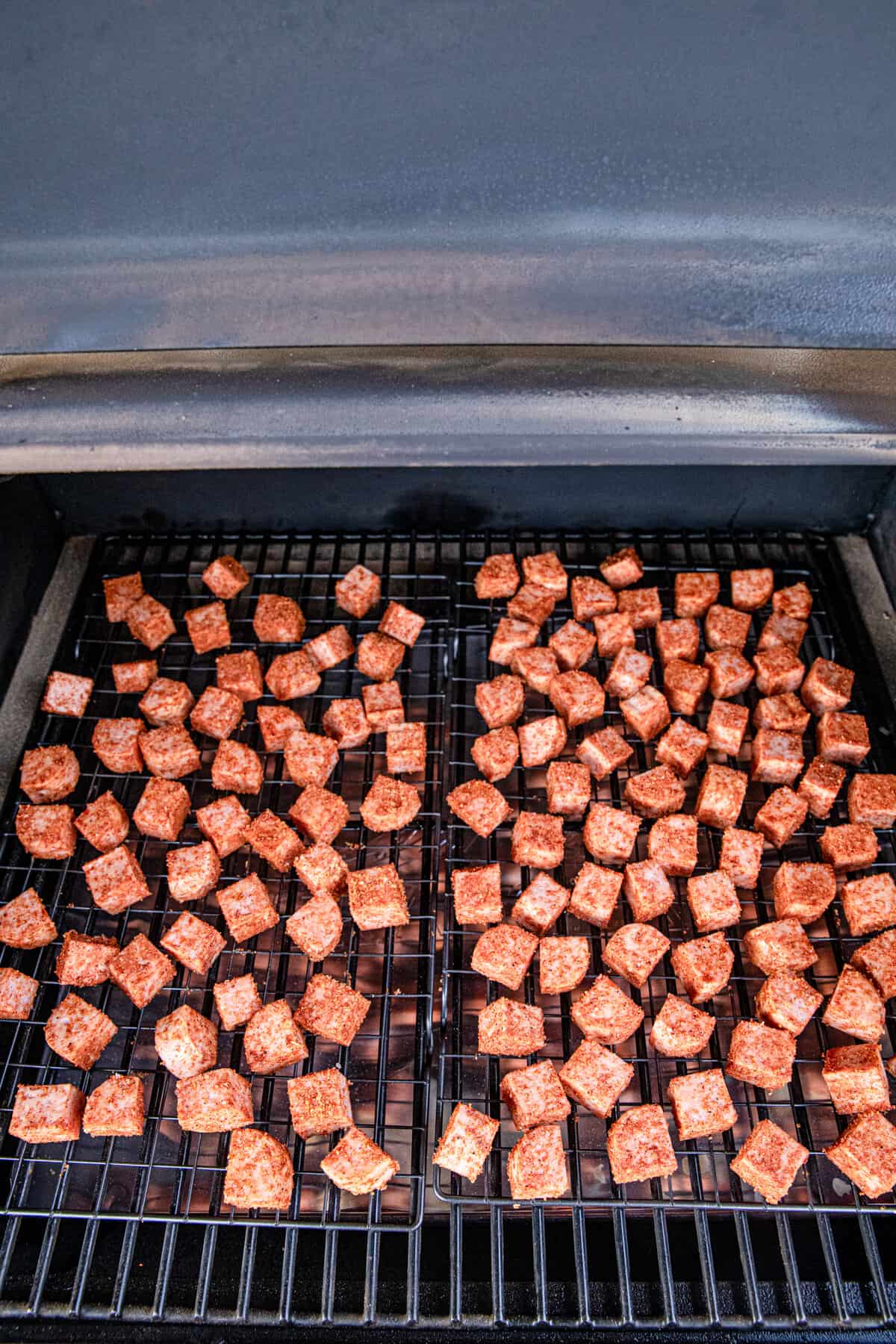 Smoking seasoned Spam pieces for Spam Burnt Ends recipe