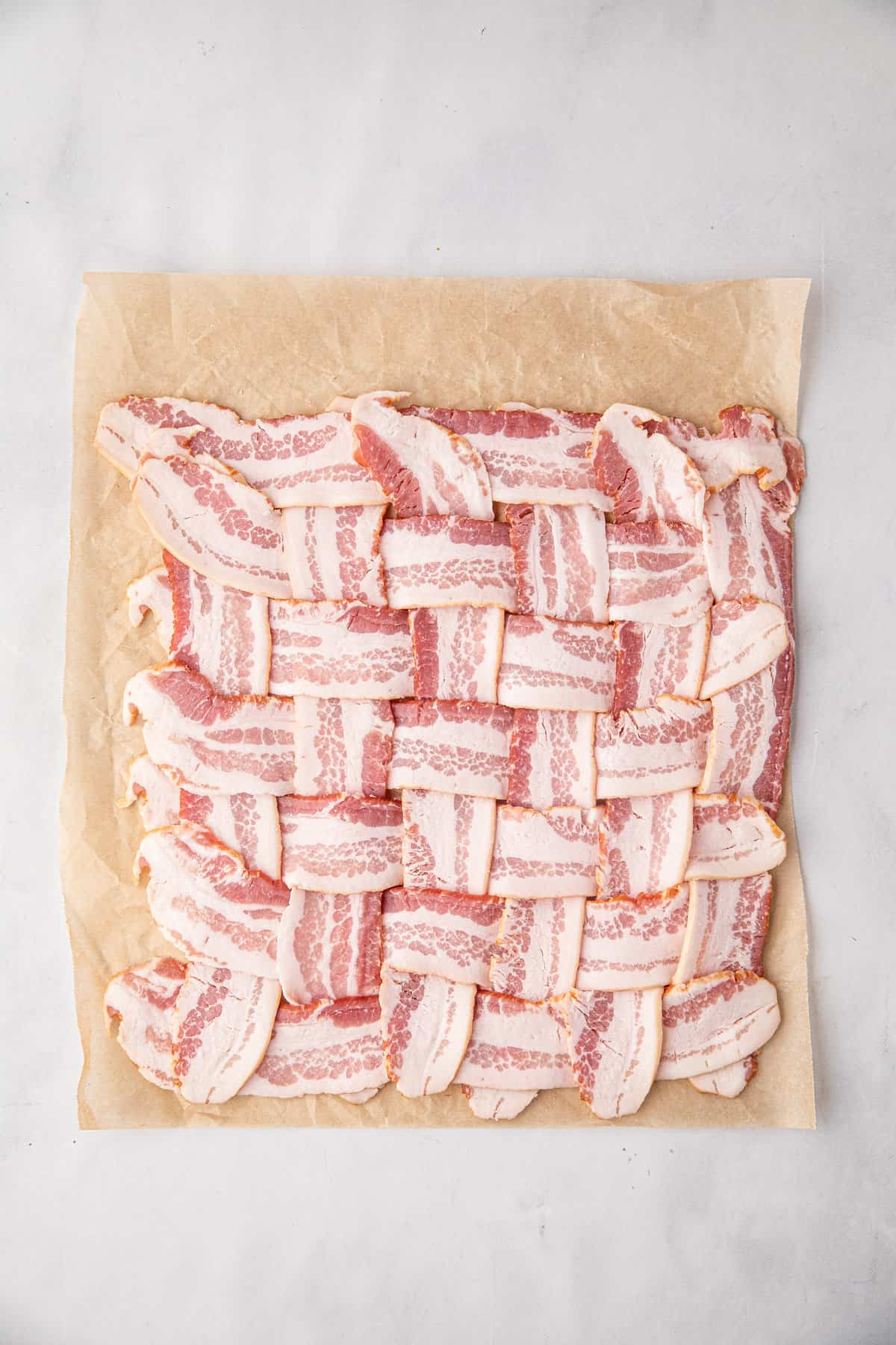 Bacon weaved on cooking paper for Bacon Explosion recipe