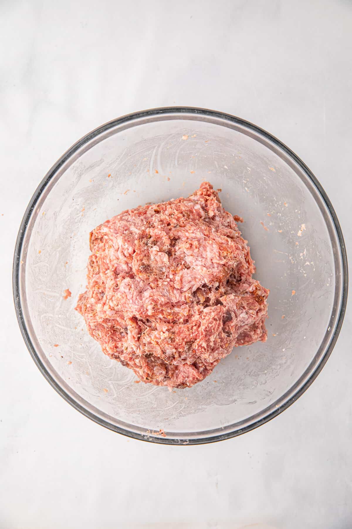 Ground pork and pork sausage in mixing bowl for Bacon Explosion recipe