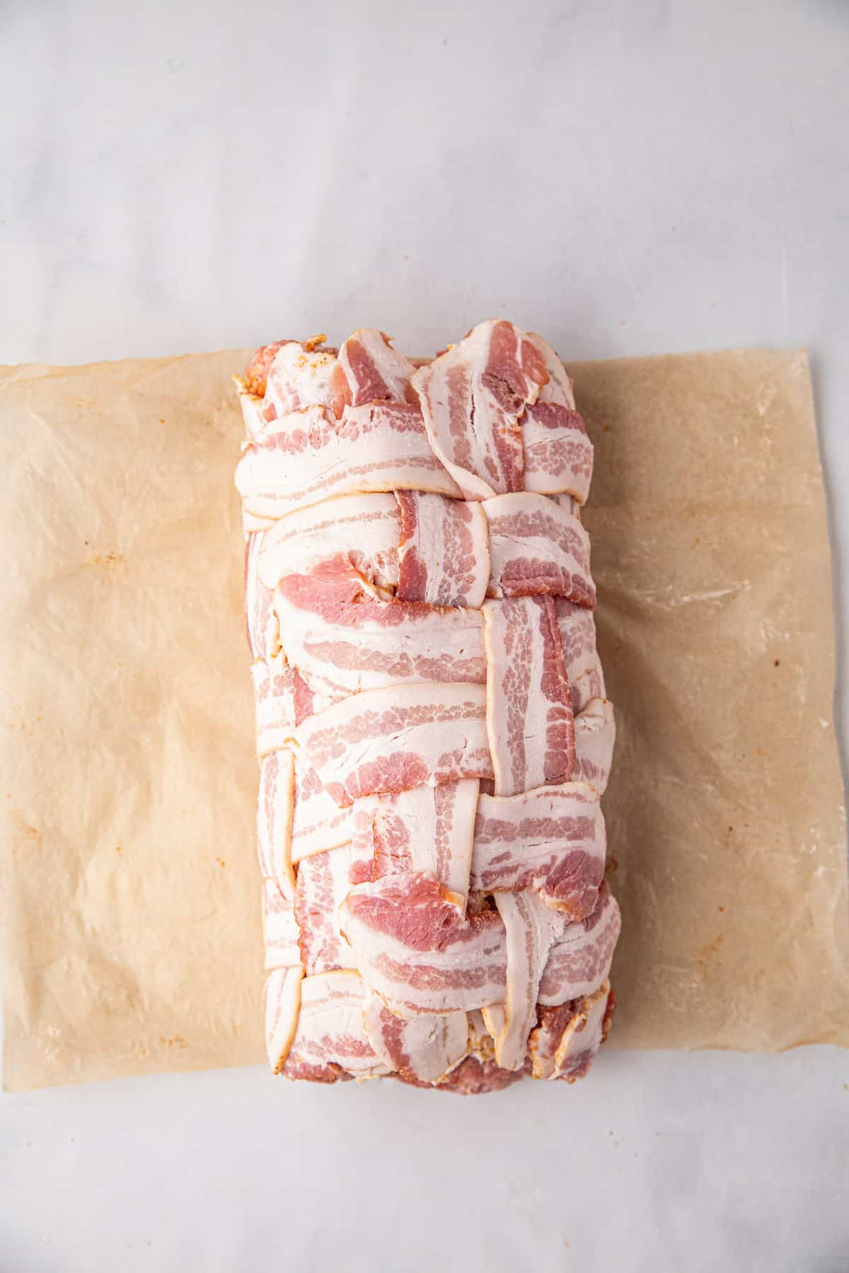 Rolling bacon weave and it's ingredients for Bacon Explosion recipe