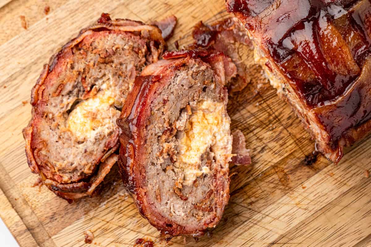 Bacon Explosion sliced on wooden cutting board