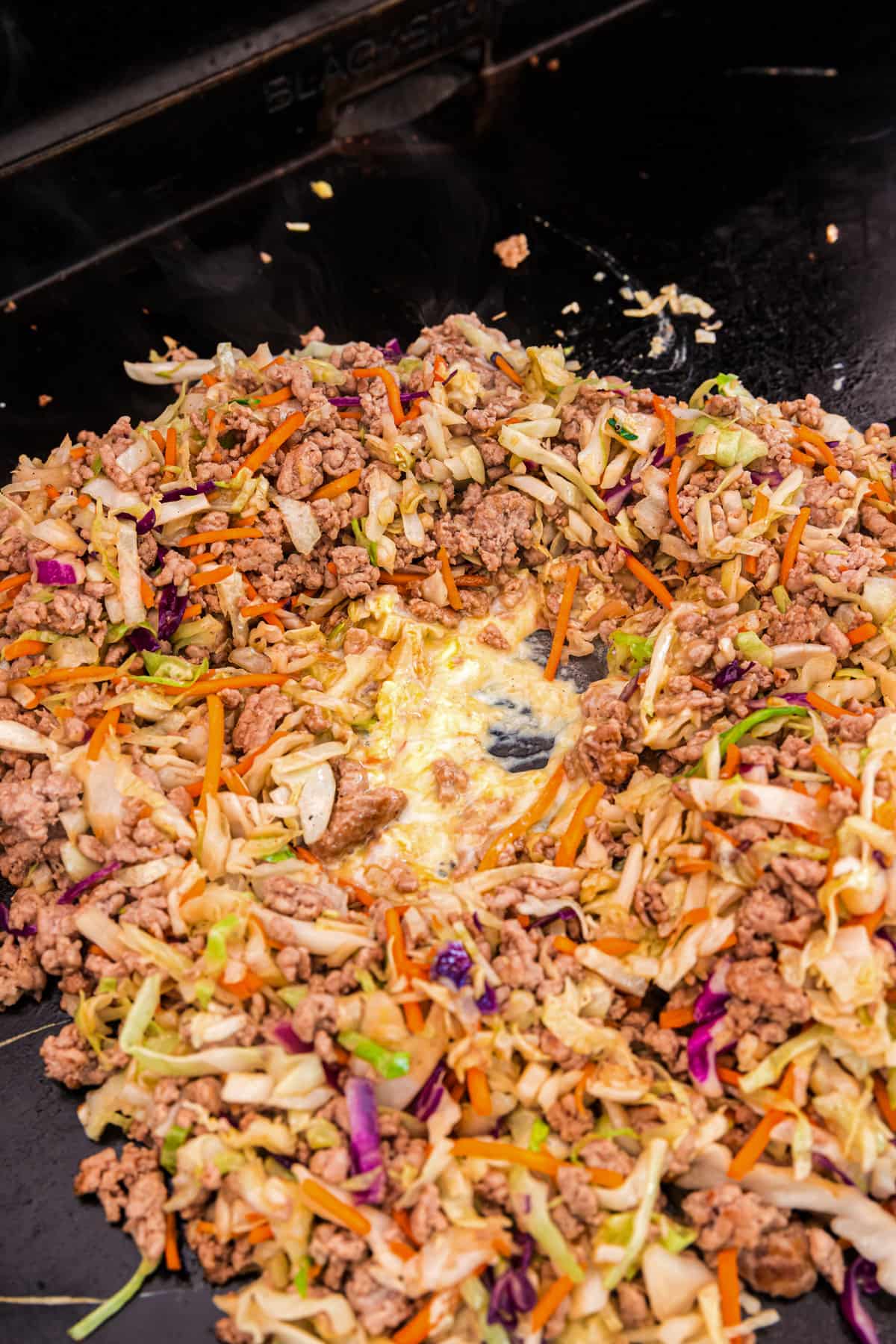 Egg Roll in a Bowl mixture on Blackstone griddle 