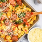 Blackstone Tortellini ingredients on grilling pan with wooden spoon