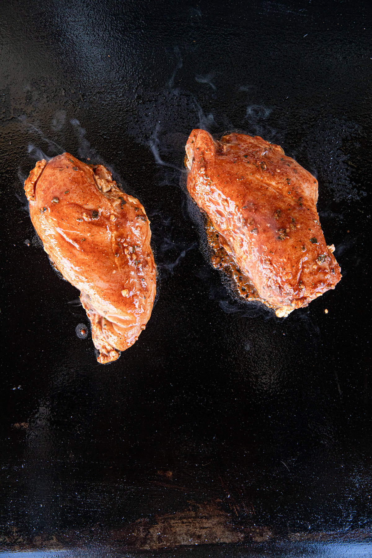 Marinaded chicken breasts on Blackstone Griddle for Chicken Street Tacos recipe