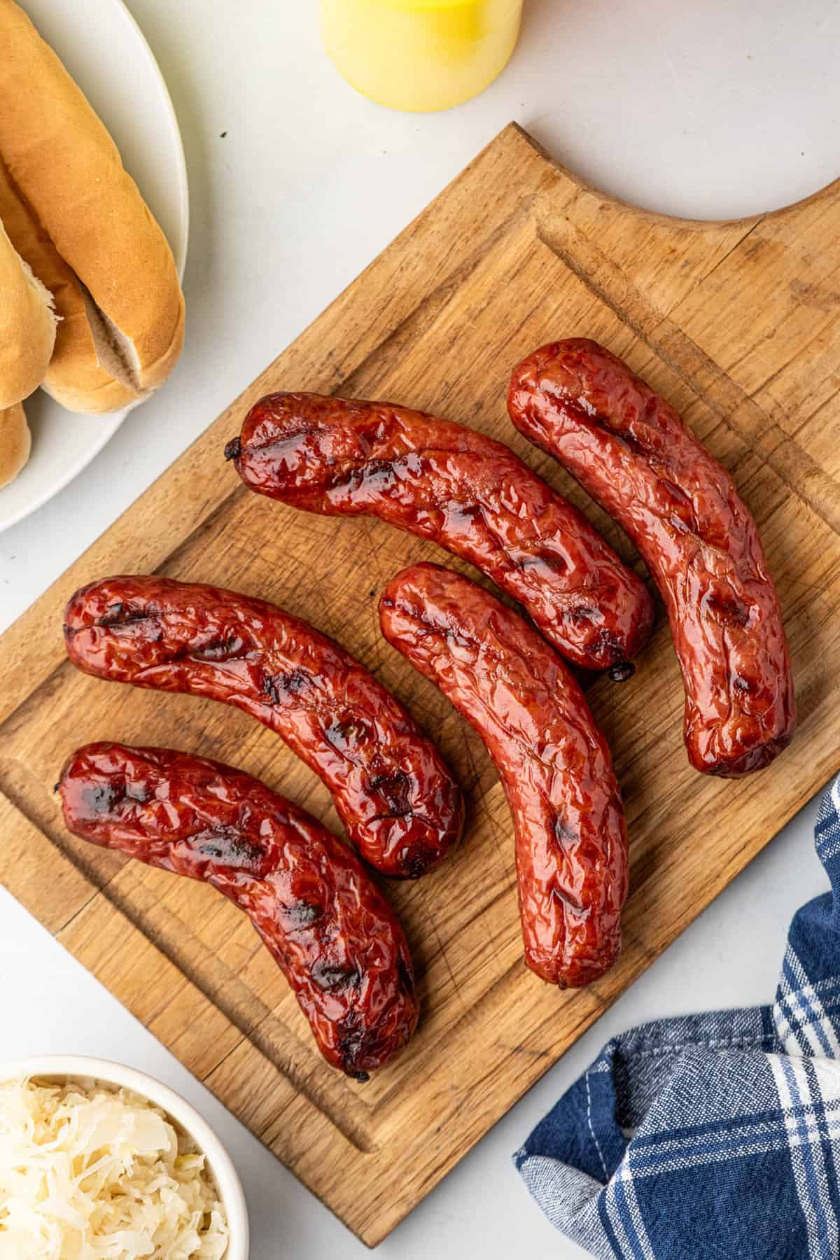 Smoked Sausge hot off the grill ready to serve from a wooden cutting board