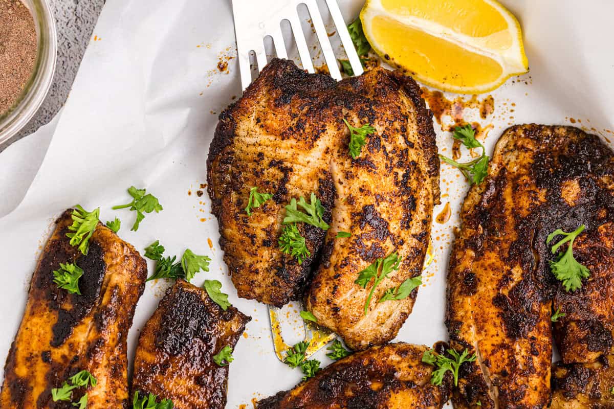 Blackstone Blackened Fish plated and ready to enjoy with a fresh lemon slice for seasoning