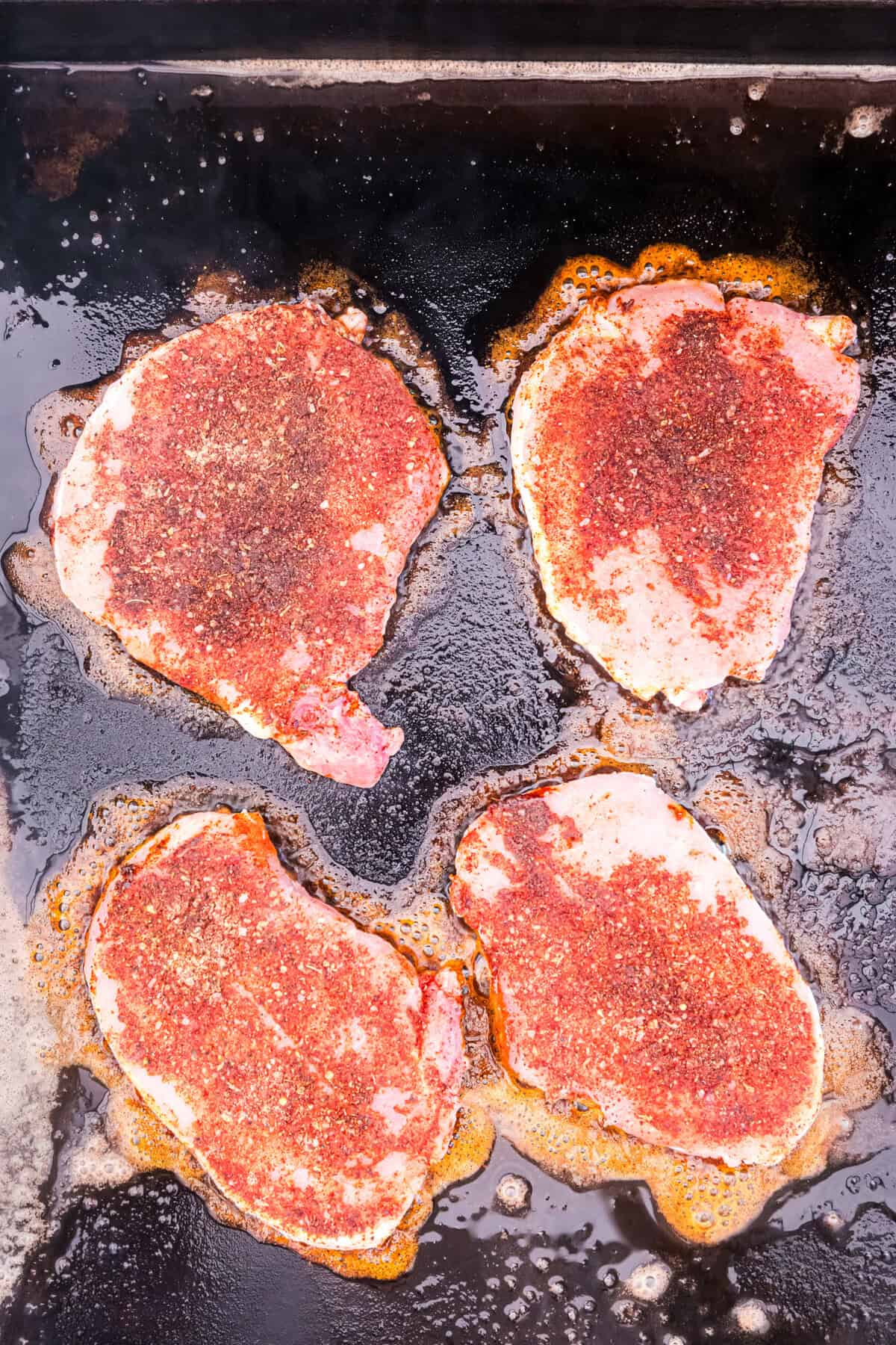 Blackstone Blackened Pork Chops on the griddle