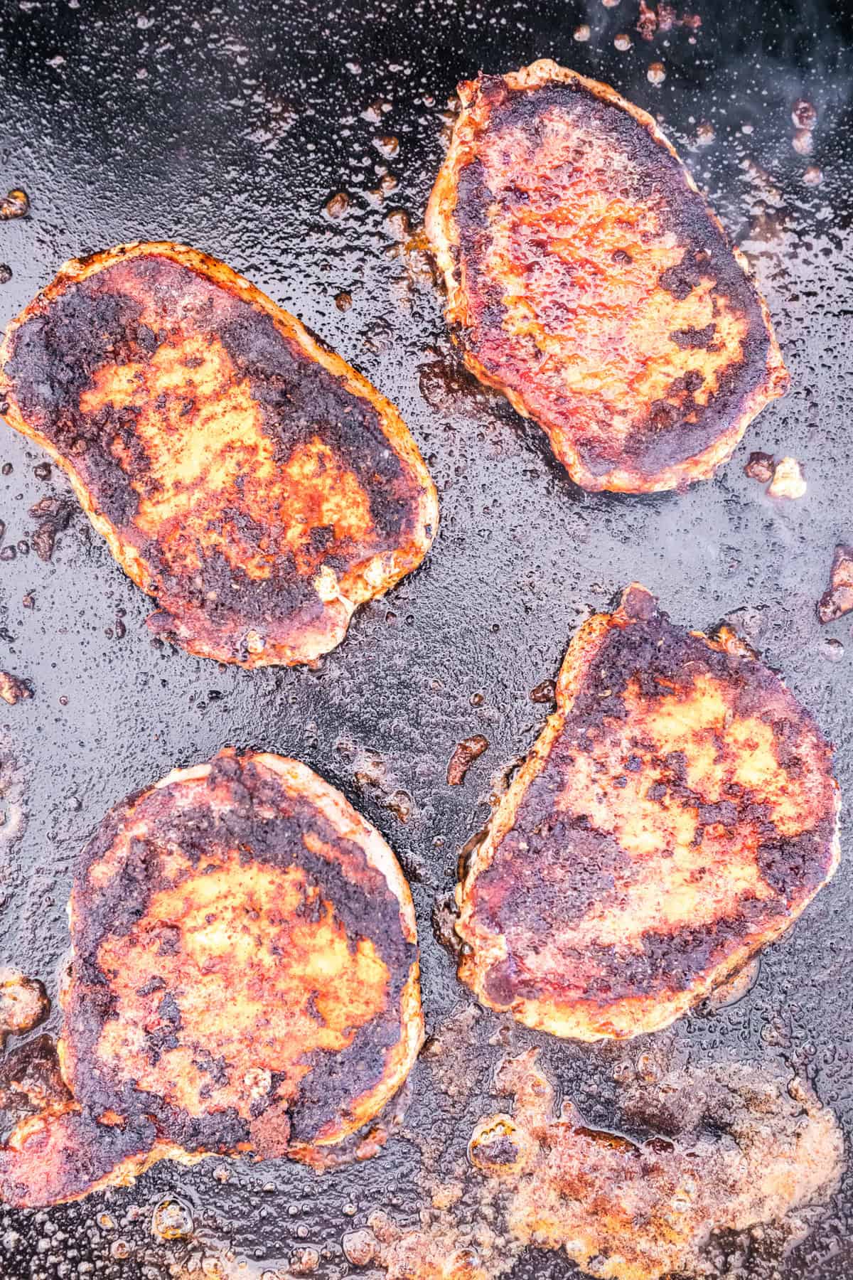 Blackstone Blackened Pork Chops on the griddle