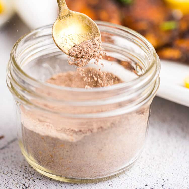 Closeup square image of Blackened Seasoning in jar with spoon