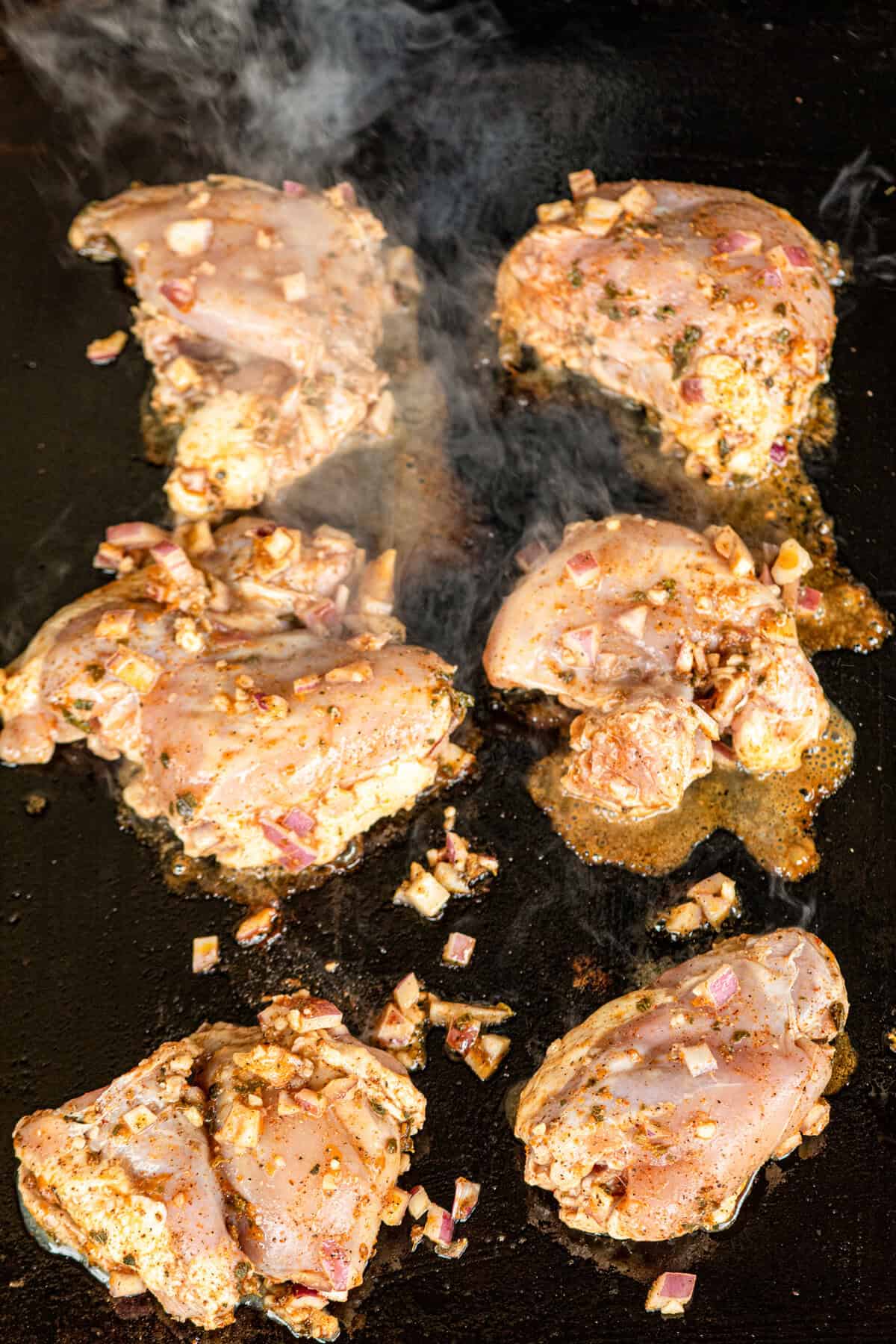 Marinaded chicken on Blackstone griddle for Pollo Asado recipe