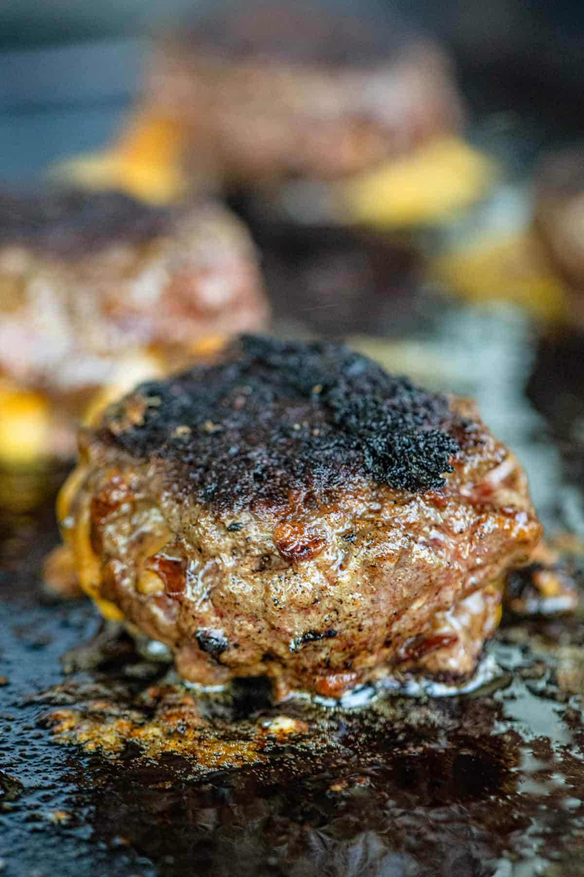 Bacon Cheese Stuffed Burger patties on Blackstone griddle