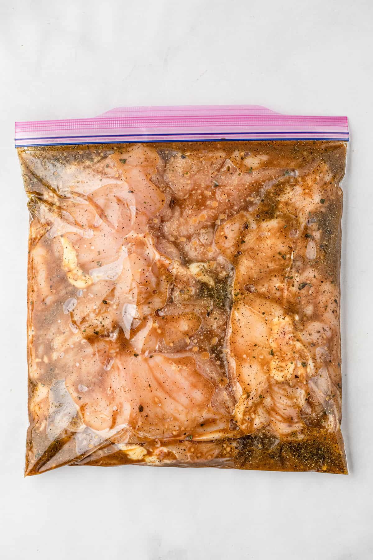 Chicken breasts submerged in Chicken Marinade in gallon bag