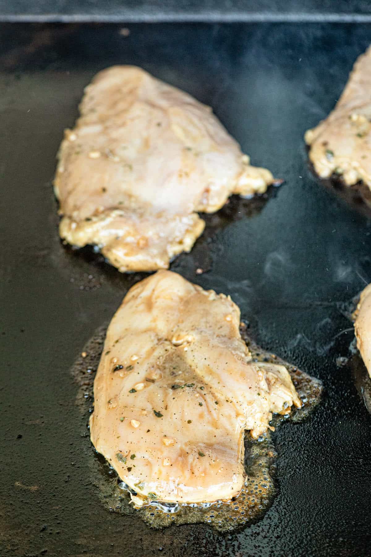 Marinaded chicken breasts on Blackstone griddle