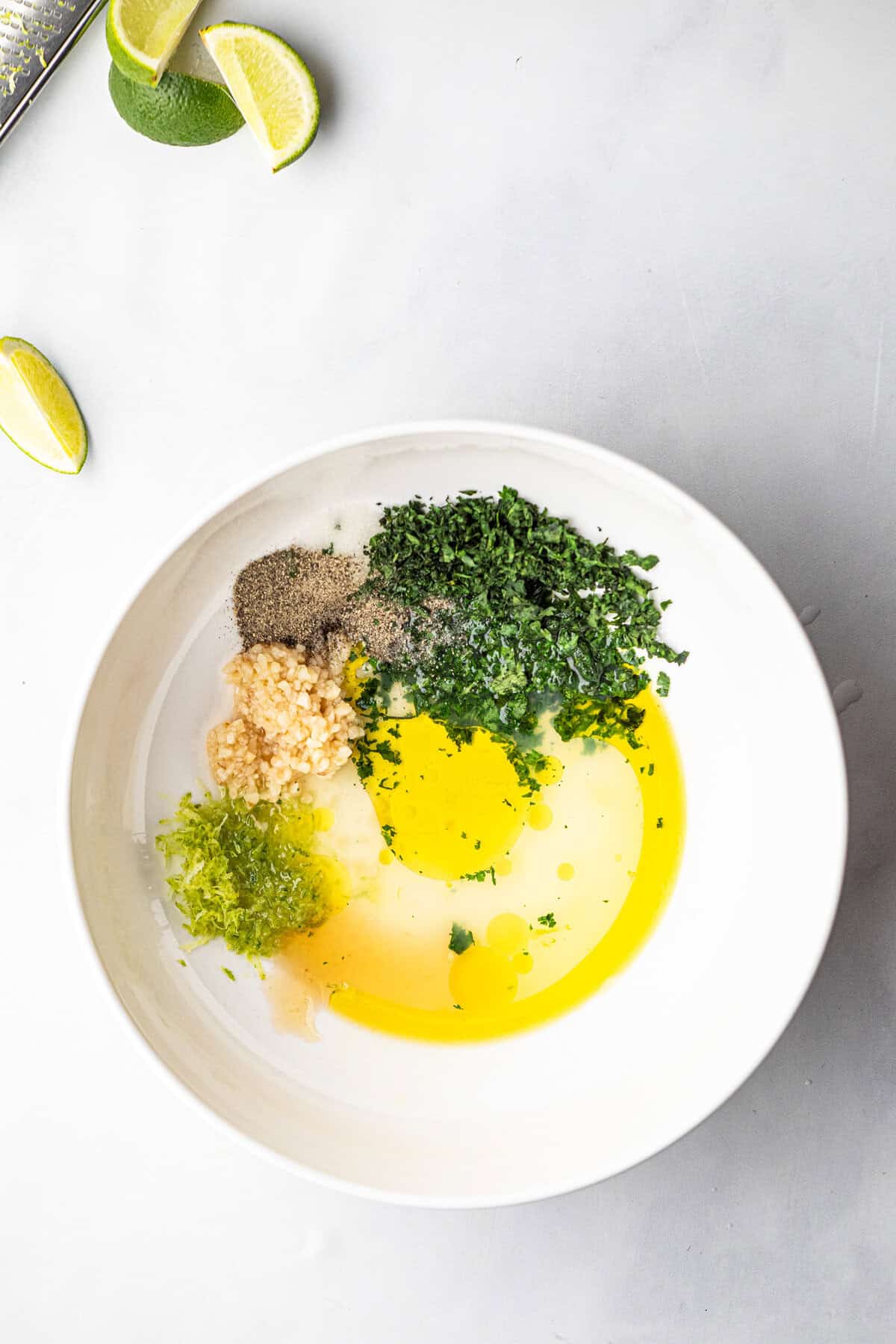 Marinade fingredients or Grilled Cilantro Lime Chicken in shallow bowl