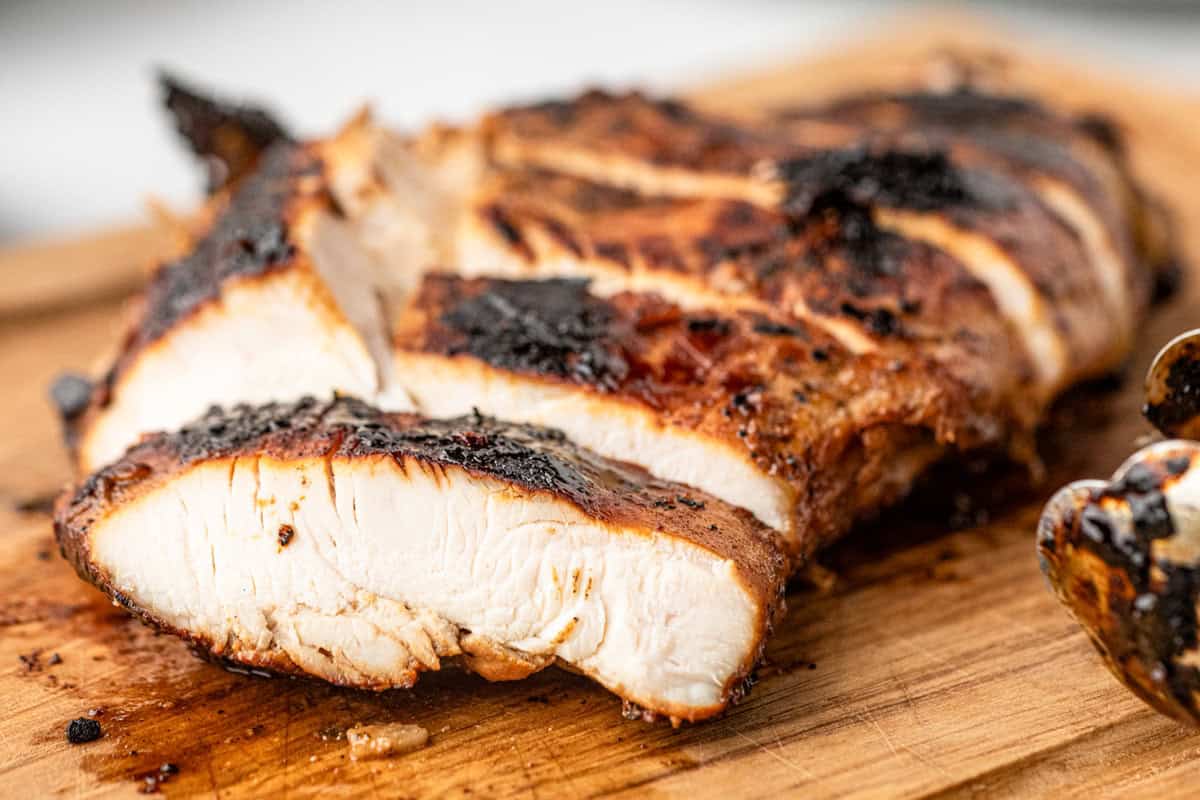 Sliced chicken breast in Chicken Marinade on wood cutting board