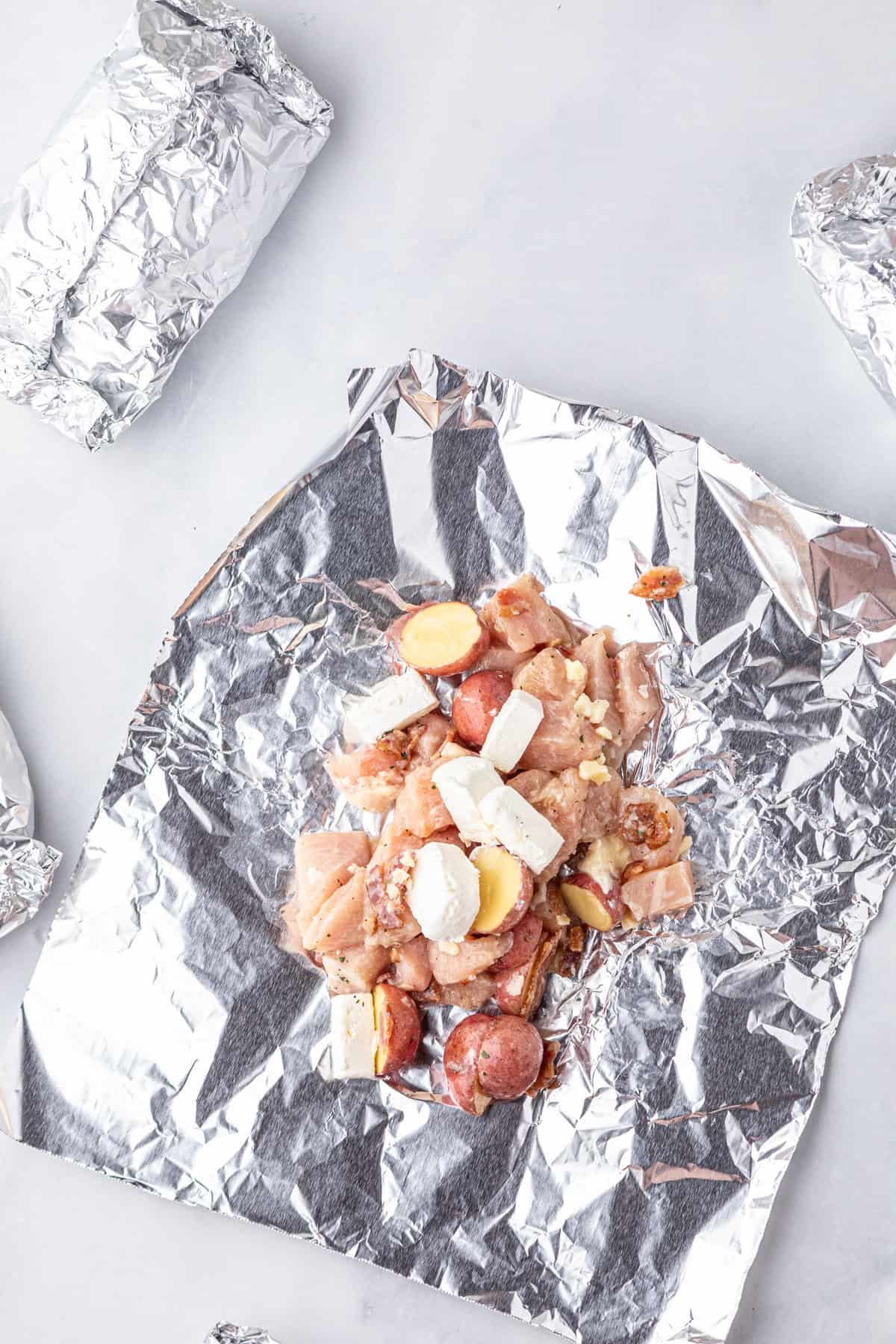 Adding Crack Chicken Foil Packets ingredients to tin foil