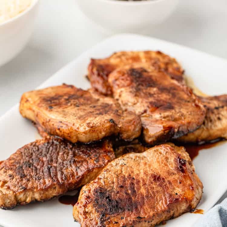 White plate with grilled pork chops on it