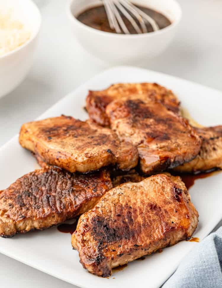 White plate with grilled pork chops on it