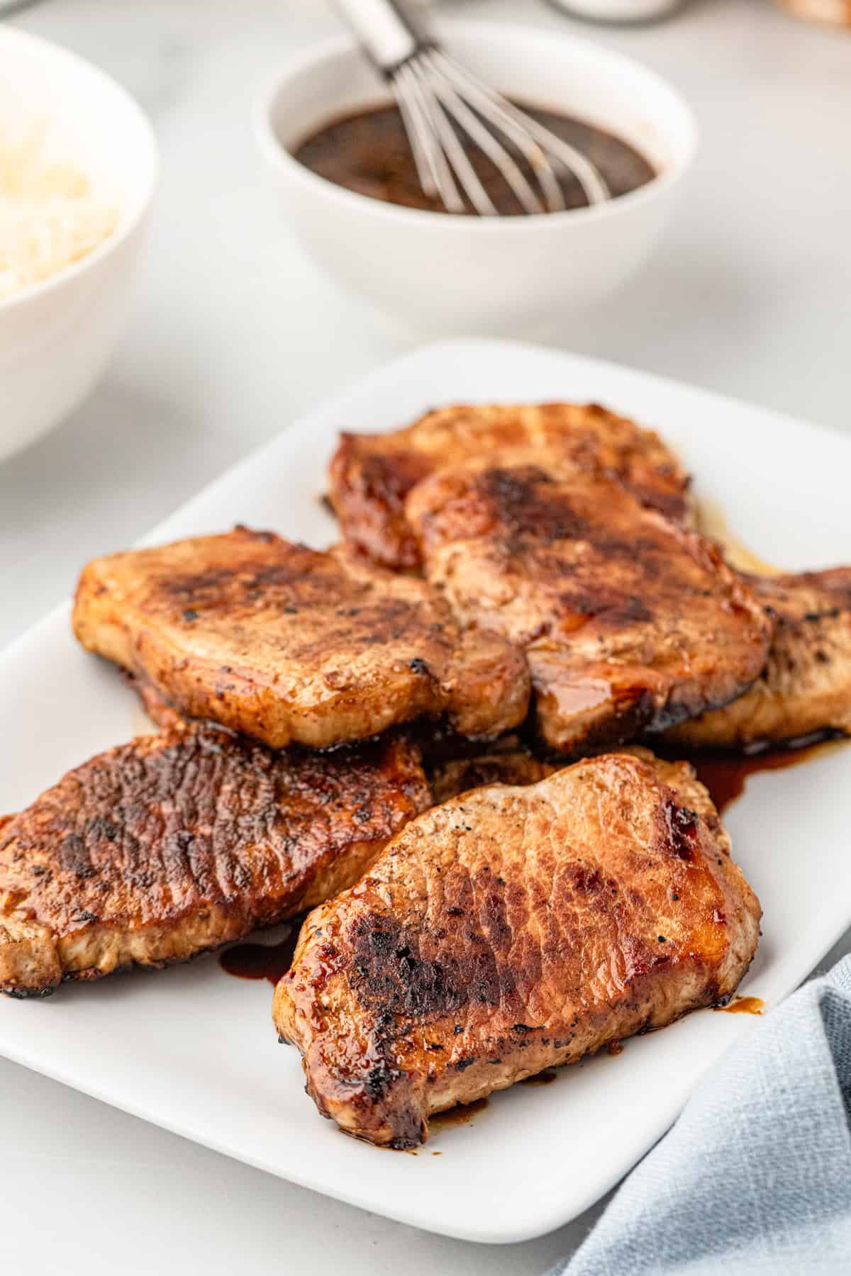 White plate with grilled pork chops on it
