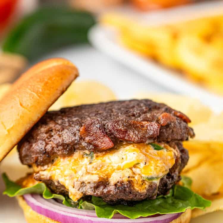 Jalapeno Popper Stuffed Burgers with topping and sliced bun