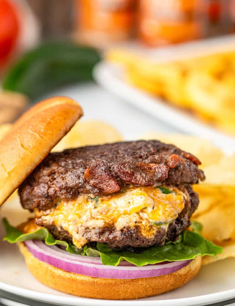 Jalapeno Popper Stuffed Burgers with topping and sliced bun