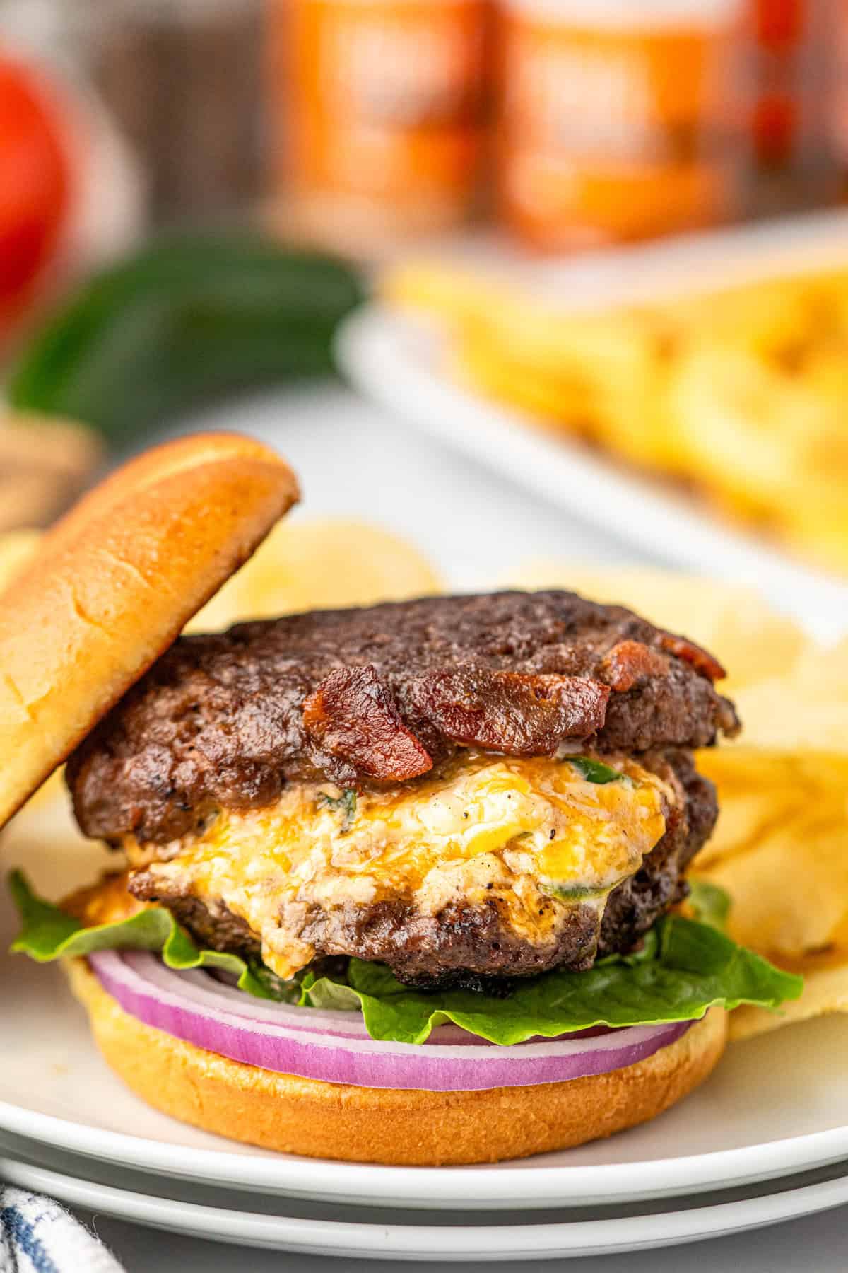 Jalapeno Popper Stuffed Burgers with topping and sliced bun