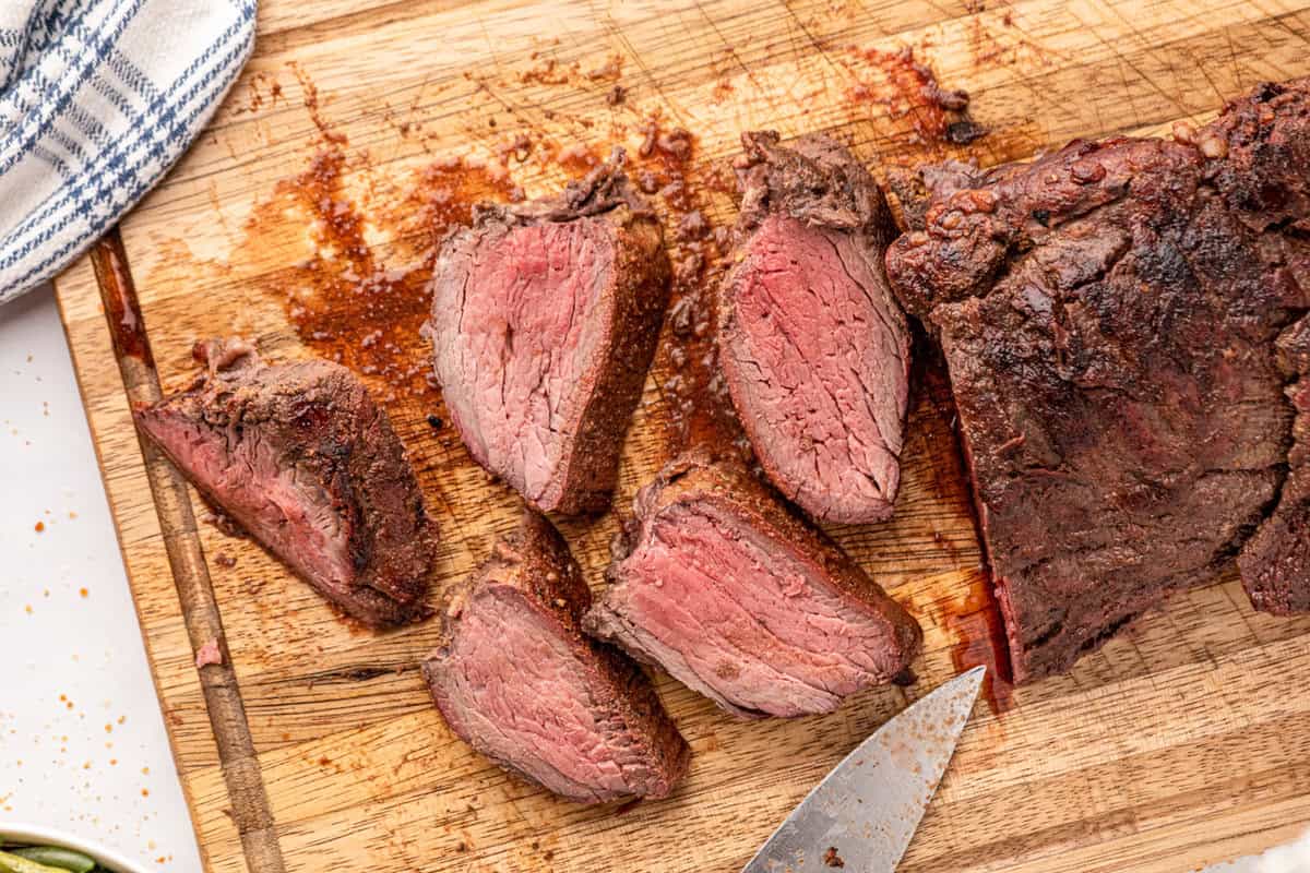 Smoked Beef Tenderloin sliced on cutting board