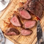 Overhead Square Image of Smoked Beef Tenderloin sliced on cutting board
