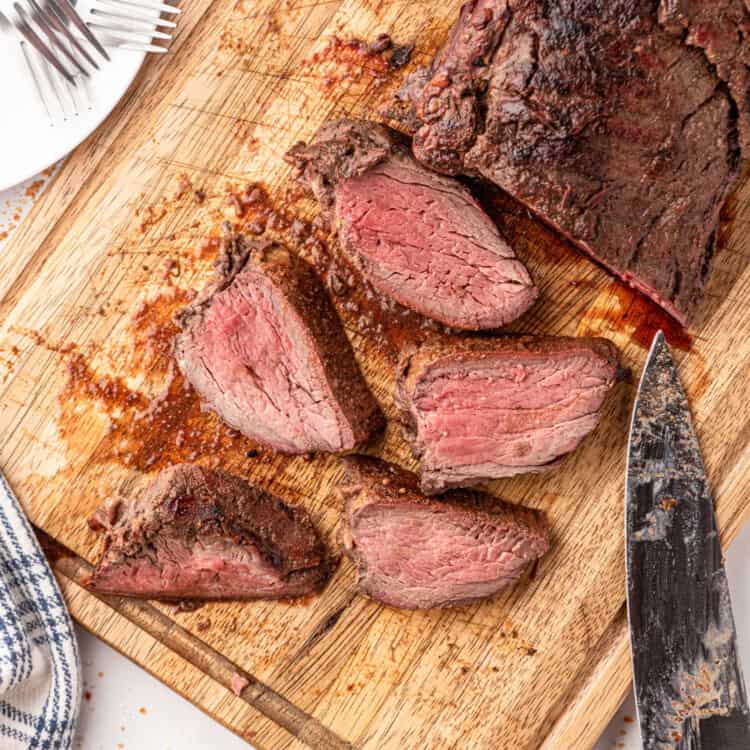 Overhead Square Image of Smoked Beef Tenderloin sliced on cutting board
