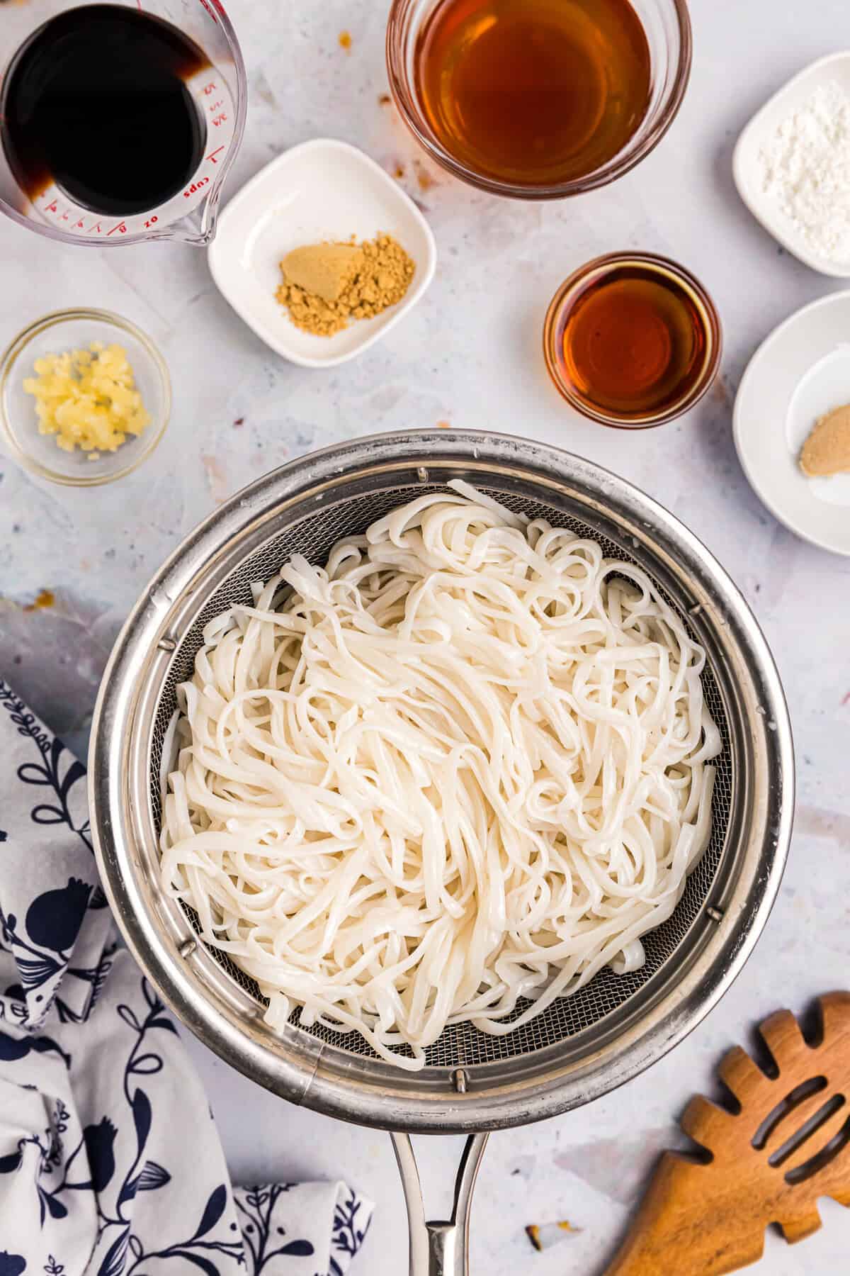 Cooked rice noodles in stovetop saucepan for Blackstone Chicken Stir Fry recipe