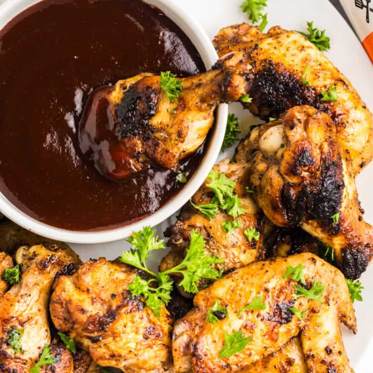 Overhead square image of Blackstone Chicken Wings on serving plate with BBQ dipping sauce