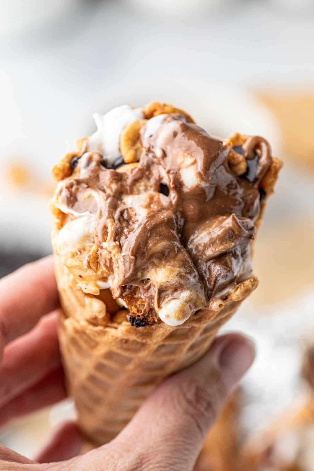 Campfire Cones hot off the grill with one hand holding it