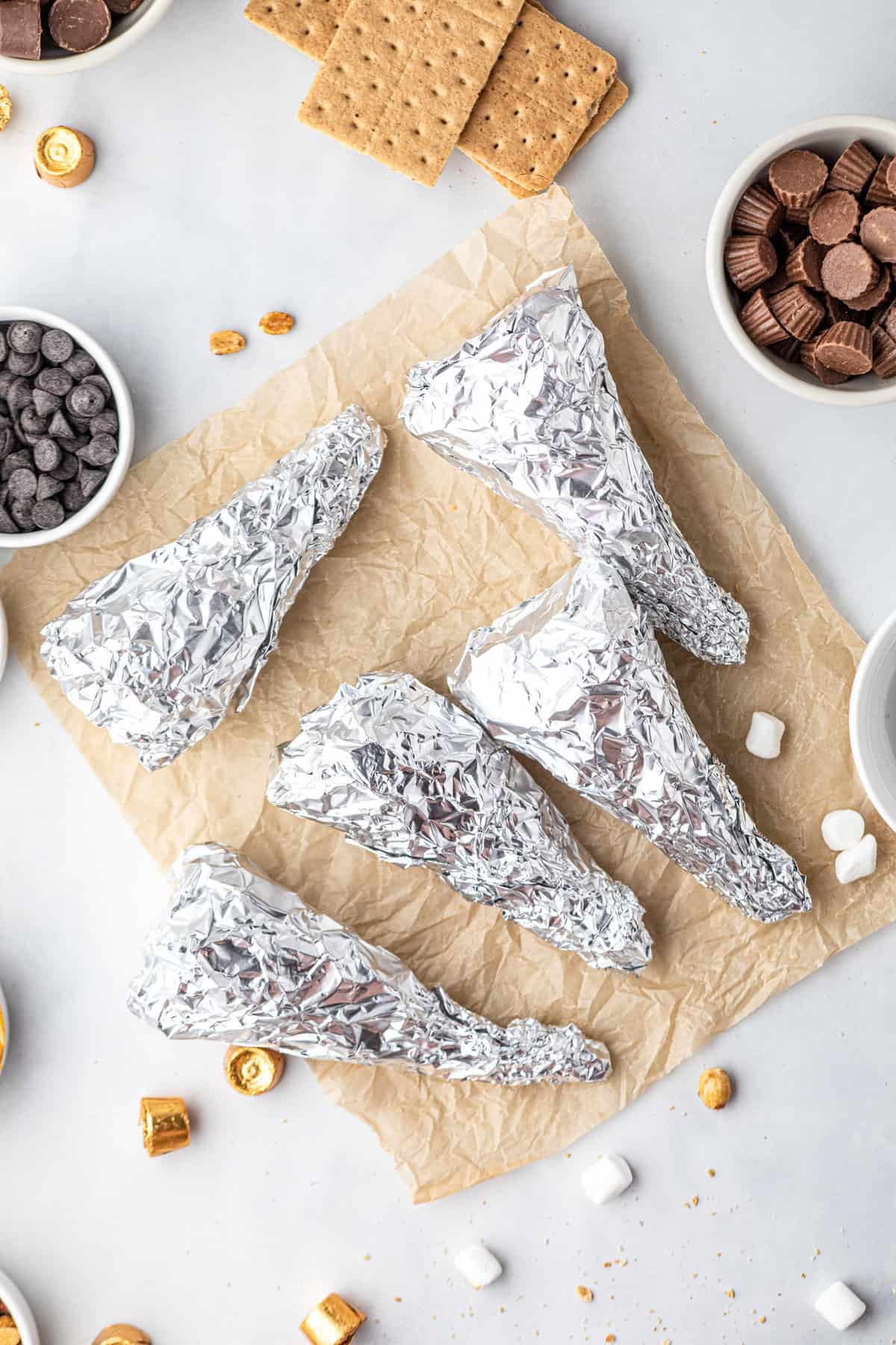 Tightly wrapping the Campfire Cones in tin foil before grilling