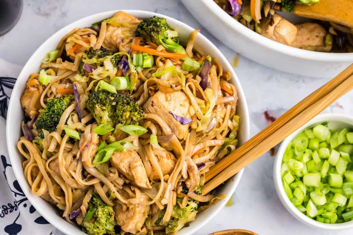Blackstone Chicken Stir Fry in a shallow serving bowl with chopsticks
