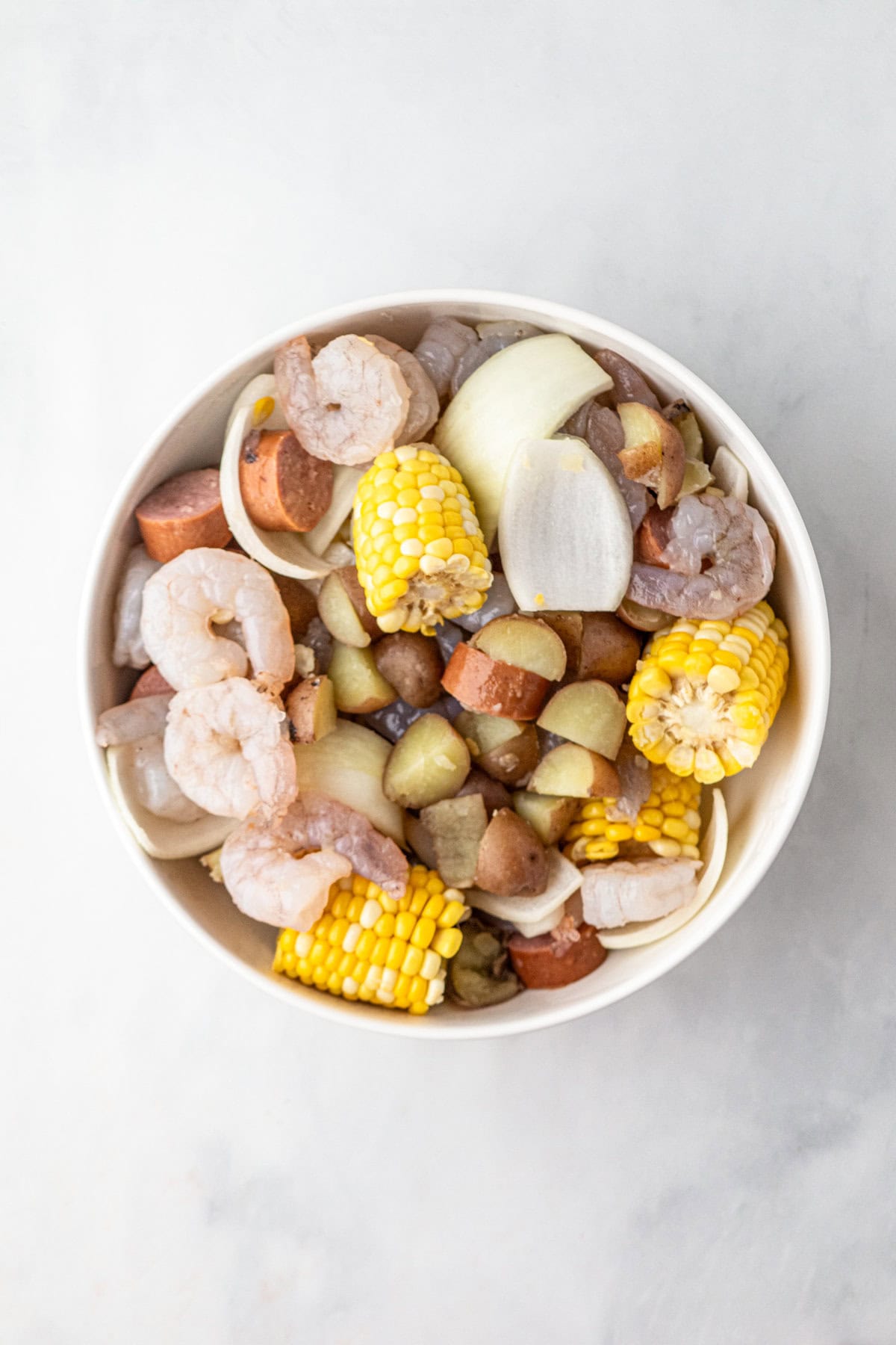 Prepared Shrimp Boil Foil Packets ingredients in large bowl
