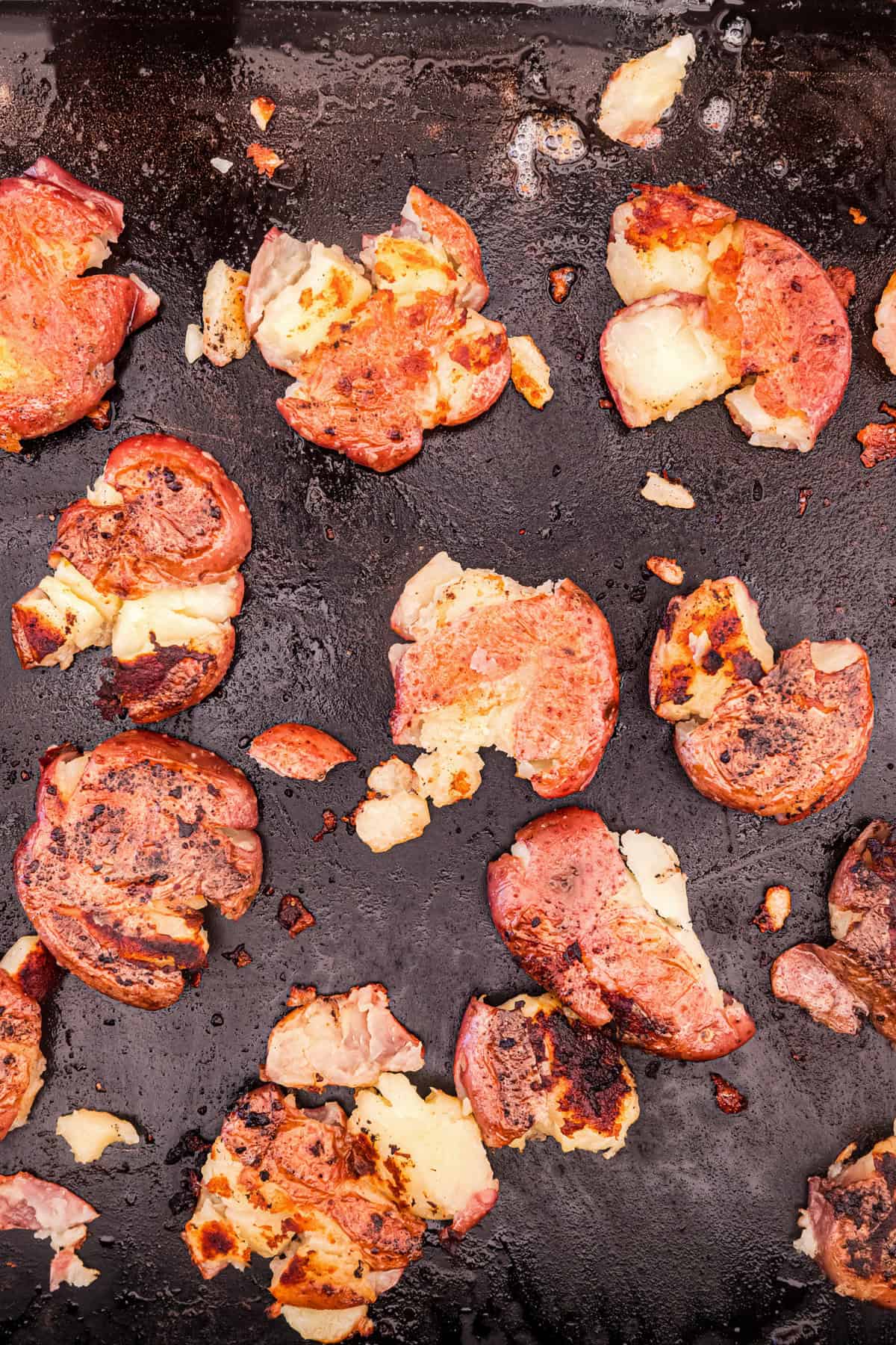 Smashed potatoes on griddle for Blackstone Smashed Potatoes recipe