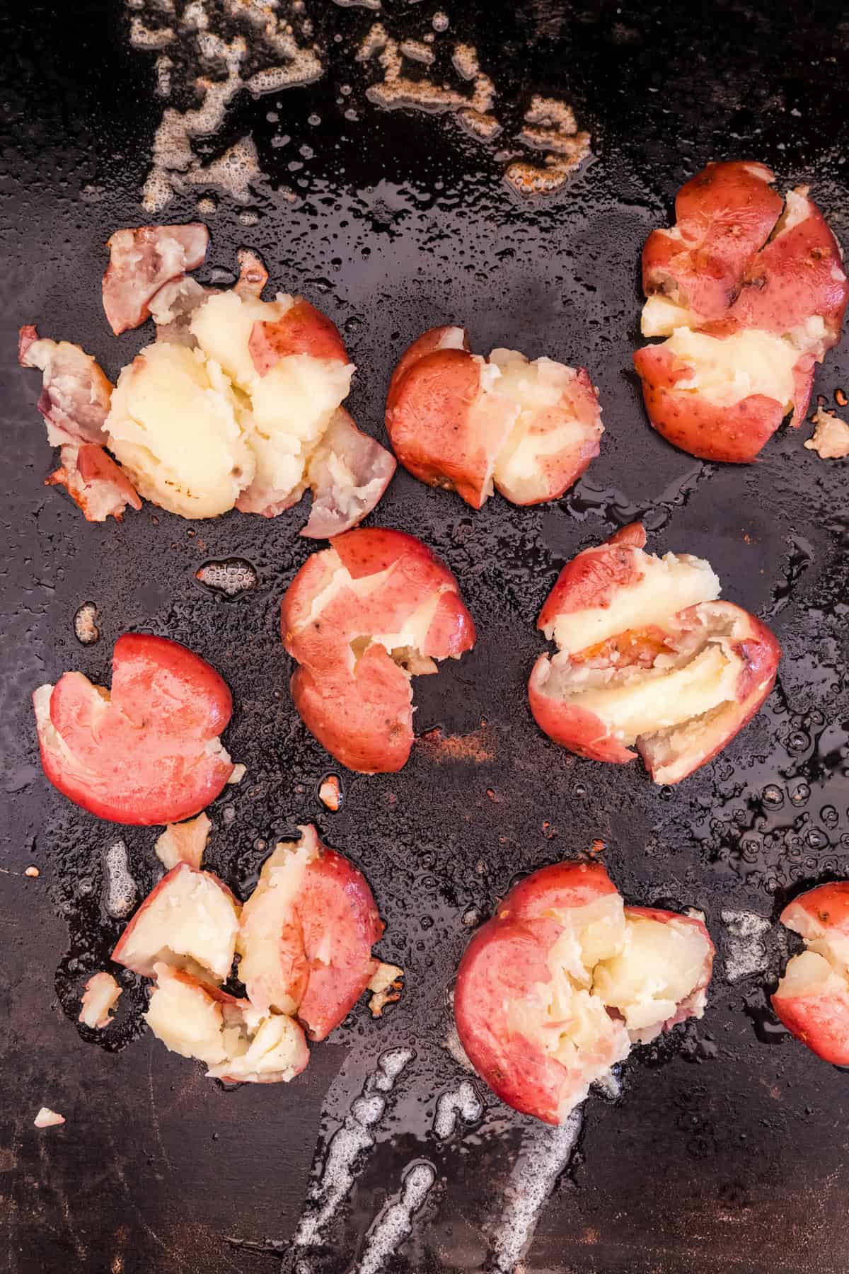 Smashed potatoes on the griddle for Blackstone Smashed Potatoes recipe