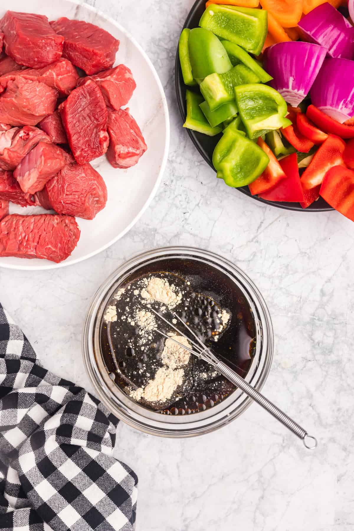 Whisking in Blackstone Beef Kabobs marinade ingredients using a small mixing bowl