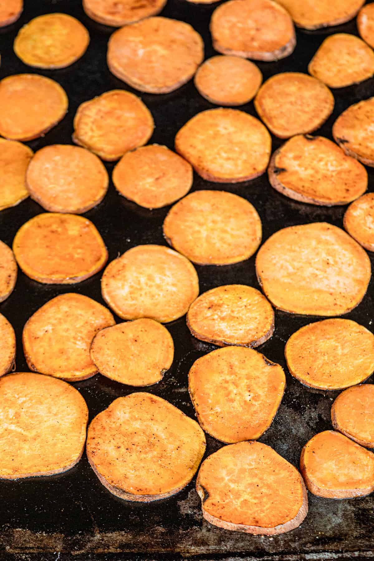 Seasoned sweet potato slices on grill for Grilled Sweet Potatoes