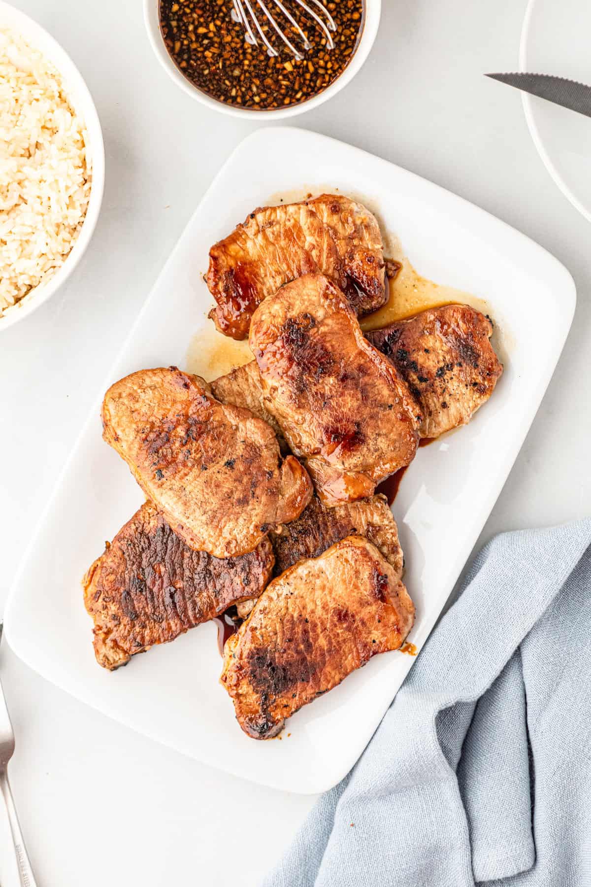Grilled Honey Garlic Pork Chops arranged on white serving plate