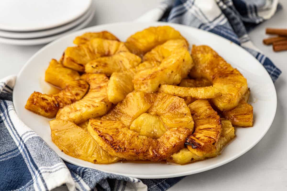 Grilled Pineapple pieces arranged on white plate