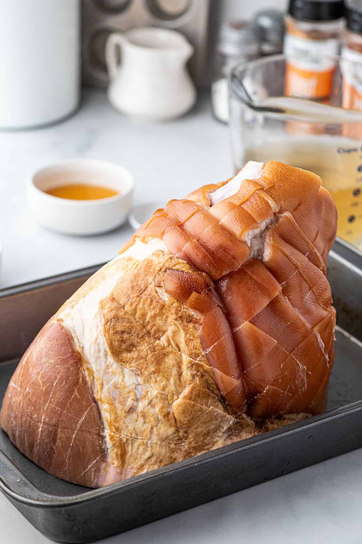 Whole picnic ham in 9x13 baking dish for Pulled Pork Ham recipe