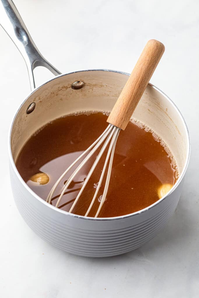 Glaze for Pulled Pork Ham in saucepan with whisk 