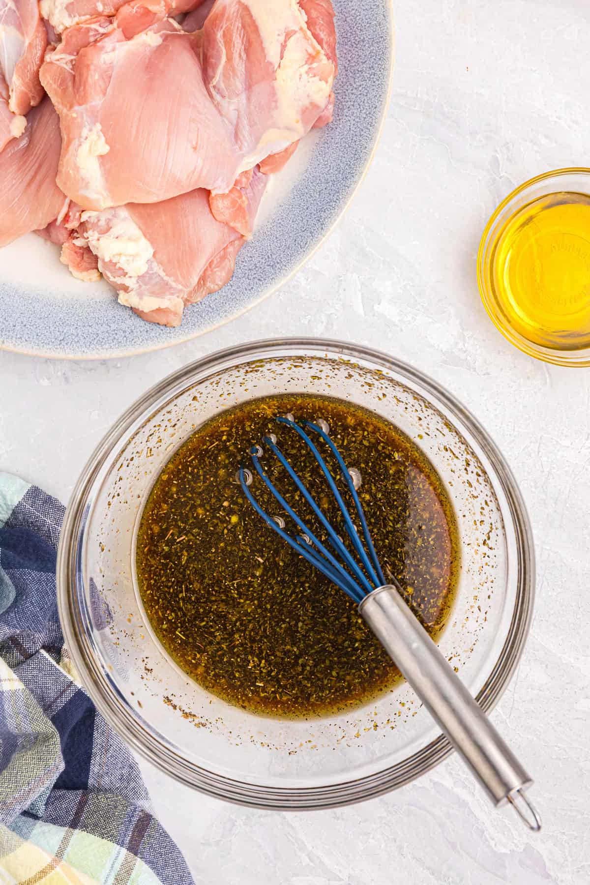 Whisking Blackstone Chicken Thighs marinade in small mixing bowl