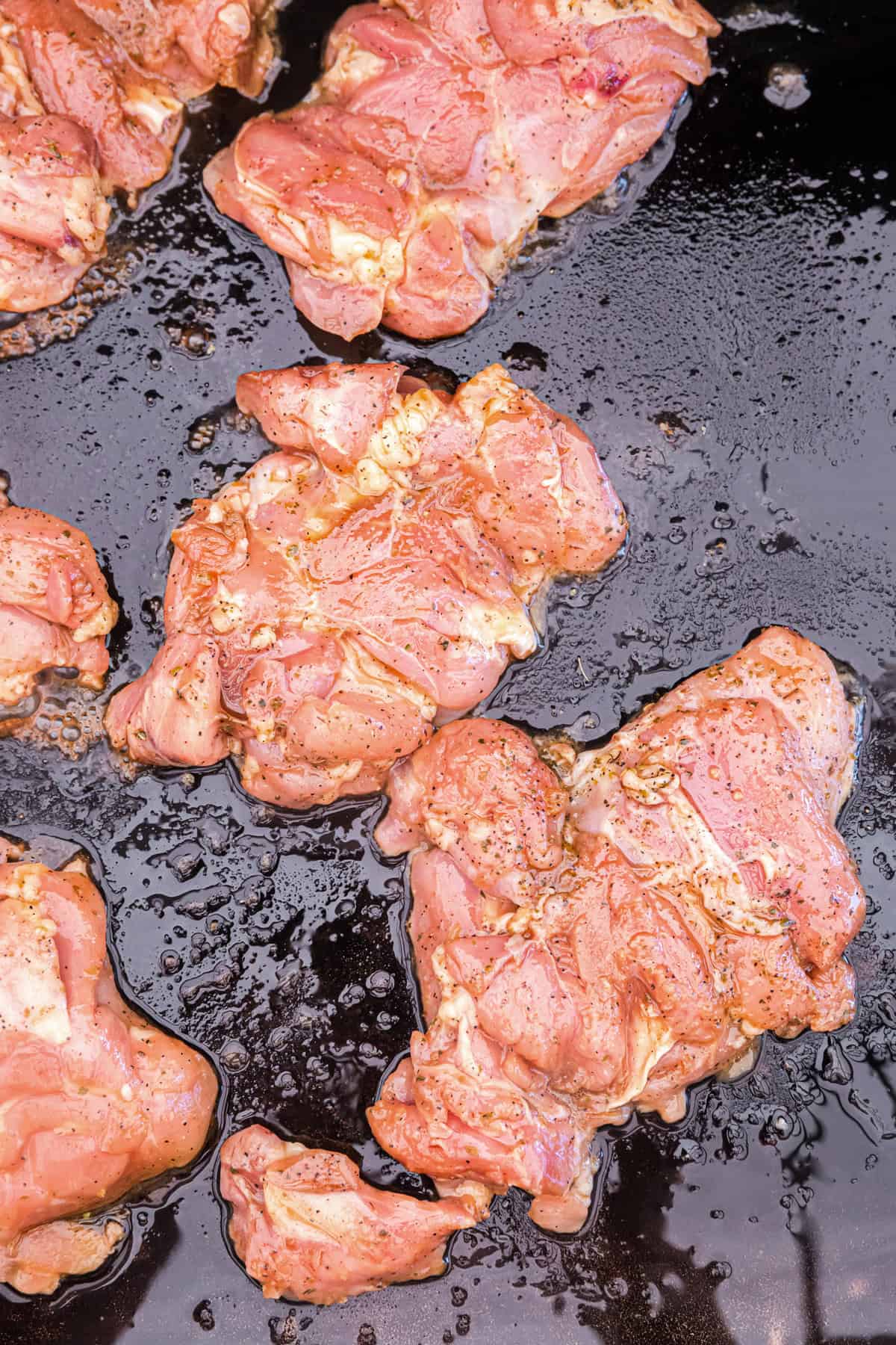 Blackstone Chicken Thighs cooking on the griddle