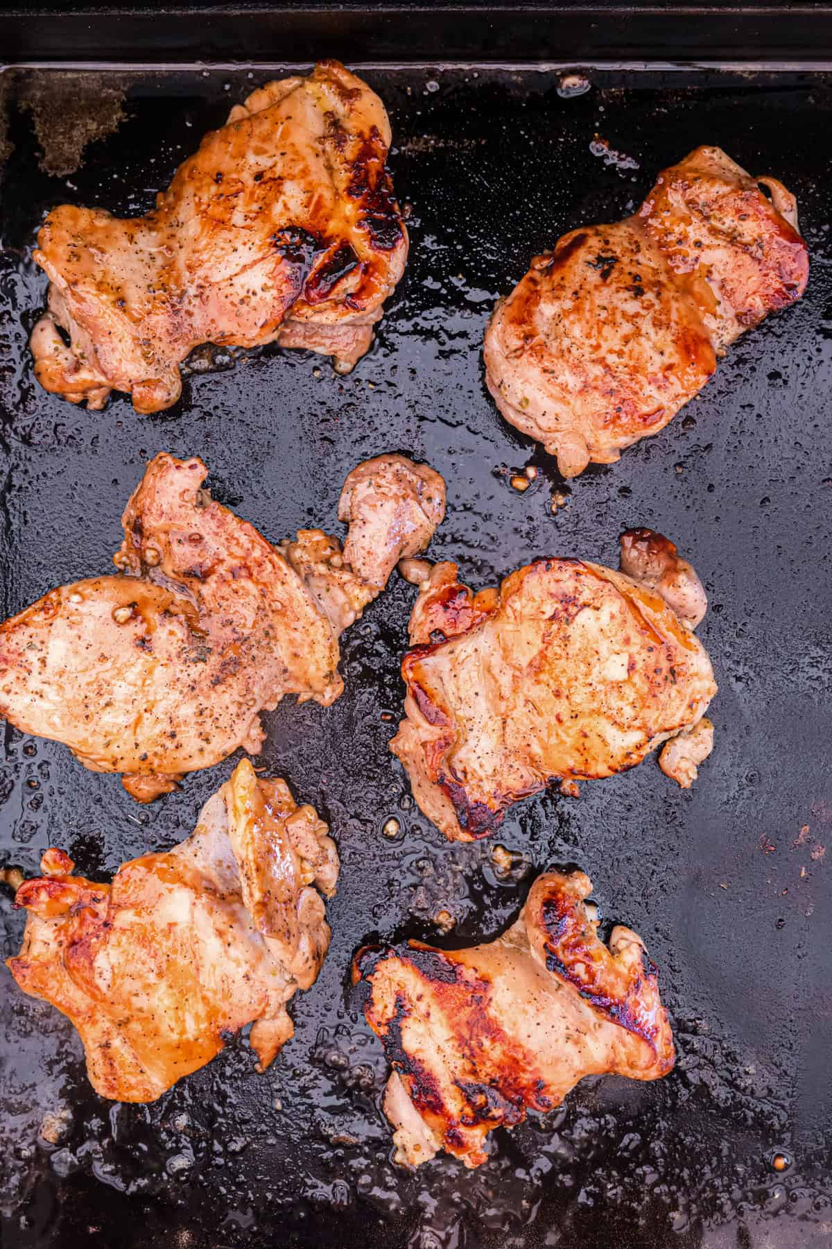 Blackstone Chicken Thighs flipped to cook on the other side