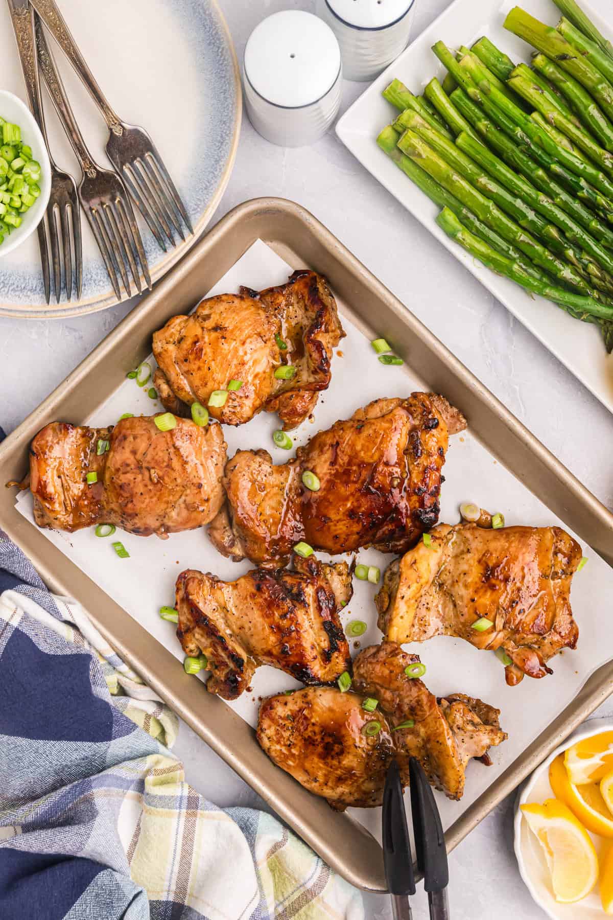 Blackstone Chicken Thighs on parchment lined cooking sheet after cooking