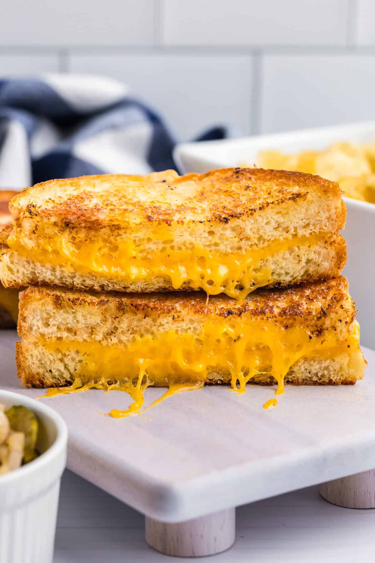 Blackstone Grilled Cheese cut in half and stacked on serving plate