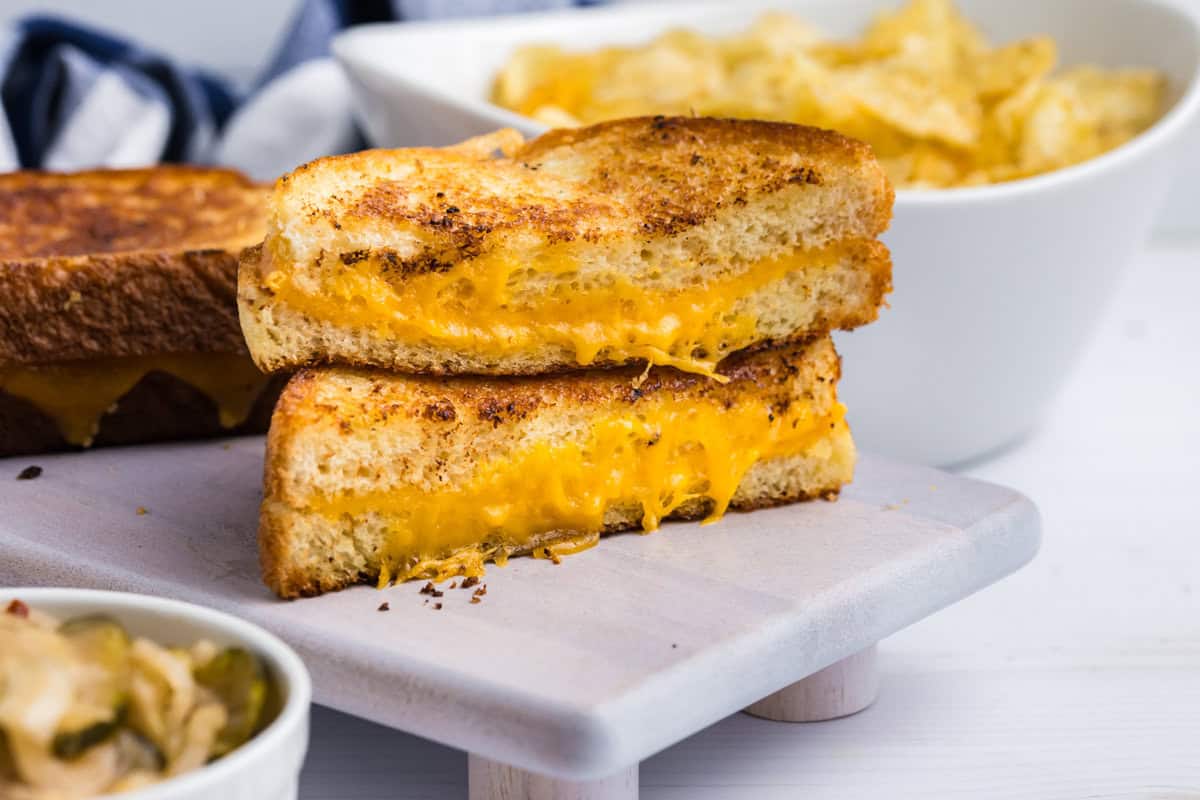 Blackstone Grilled Cheese cut in half and stacked on serving plate
